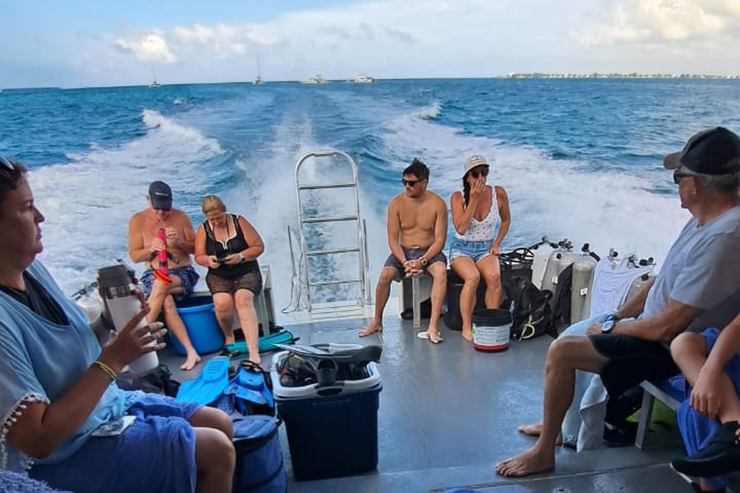 DNS Diving guests relaxing aboard the boat during a day on the water in Grand Cayman